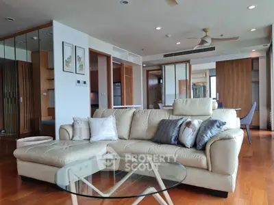 Spacious modern living room with elegant decor and large windows in luxury apartment.