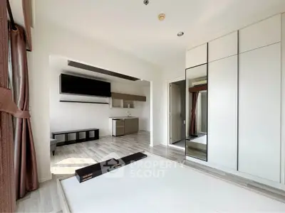 Modern open-plan studio with sleek kitchen and ample natural light