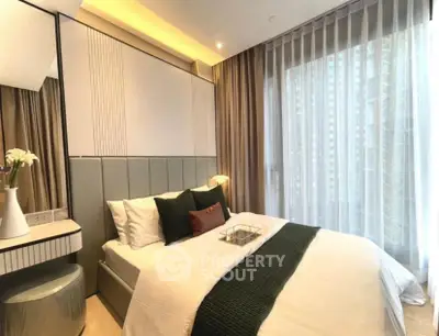 Luxurious bedroom with modern decor and large window in upscale apartment.