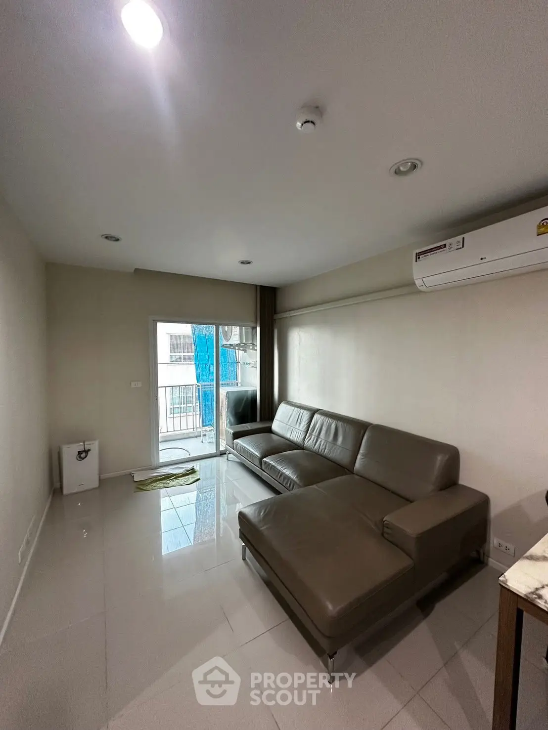 Modern living room with sleek leather sofa and air conditioning