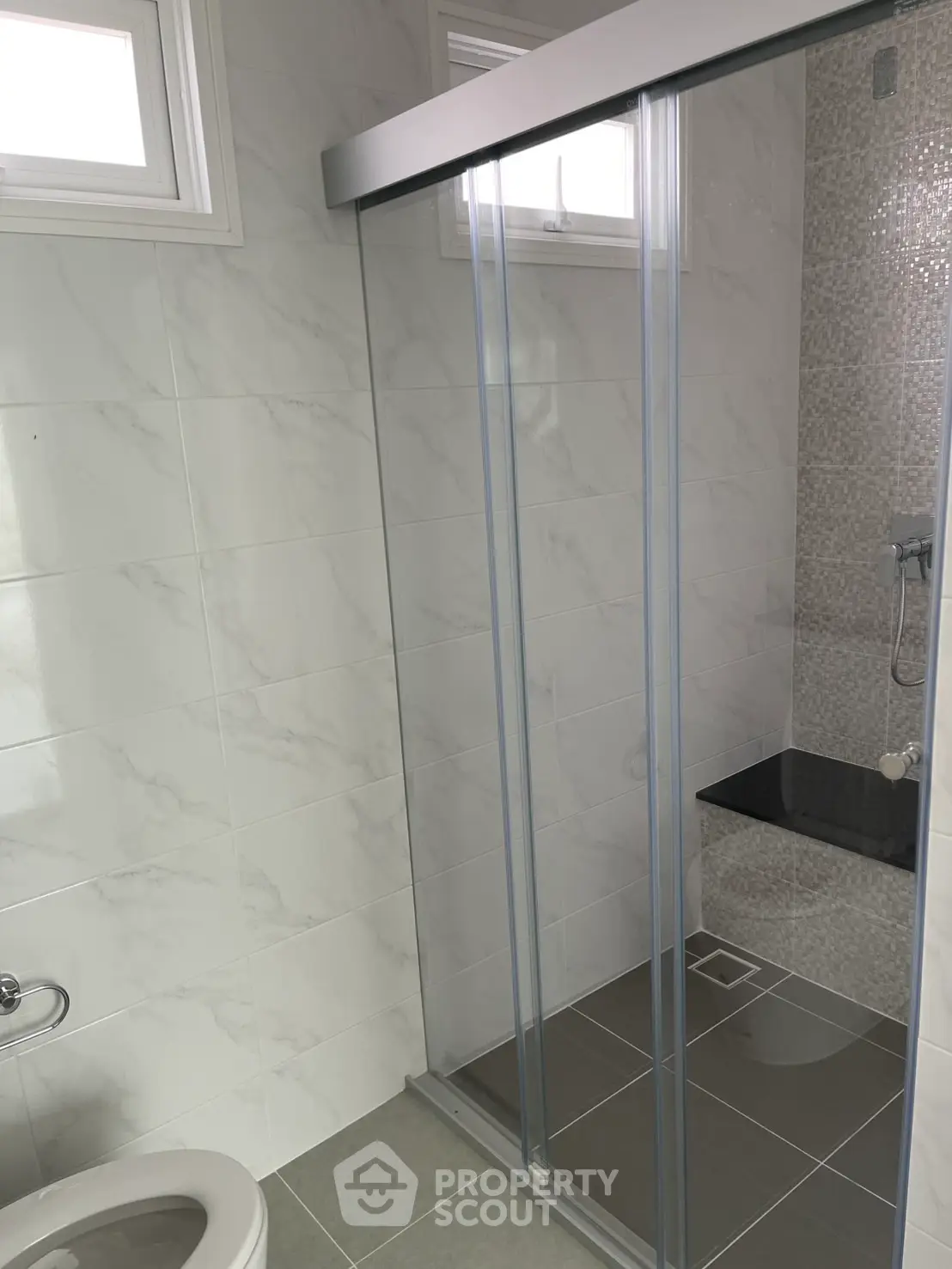 Modern bathroom with sleek shower enclosure and tiled walls