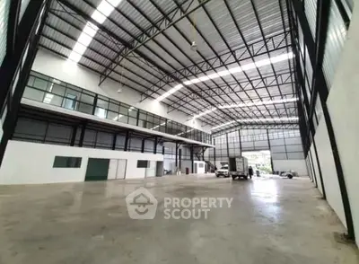 Spacious industrial warehouse with high ceilings and ample storage space.