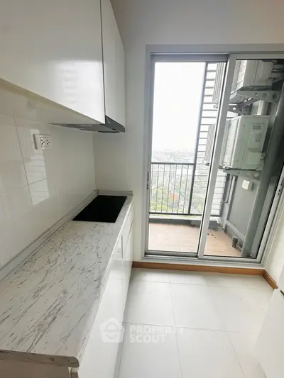 Modern kitchen with sleek design and balcony view