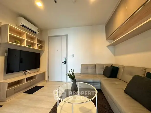 Modern living room with sleek furniture and built-in entertainment center.