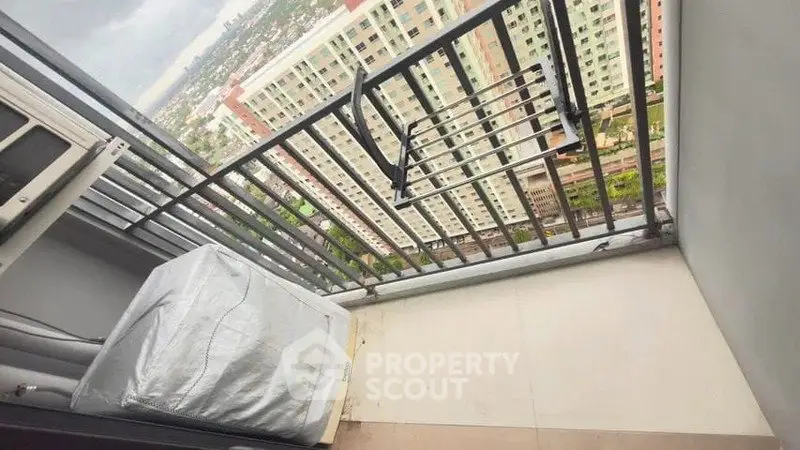 Spacious balcony with city view in modern high-rise apartment