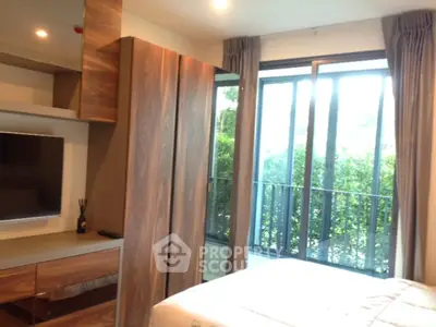 Modern bedroom with large window and stylish wooden furniture