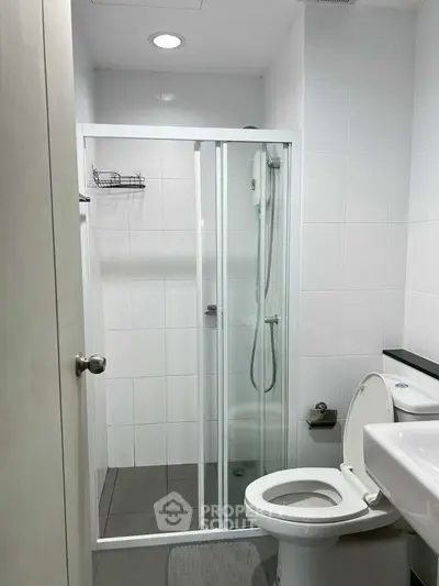 Modern bathroom with glass shower enclosure and sleek fixtures