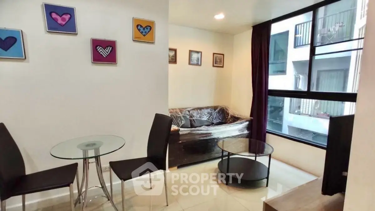 Modern living room with glass table and large window view