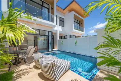Luxurious modern villa with private pool and lush greenery, perfect for tropical living.