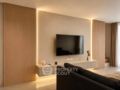 Modern living room with sleek TV setup and ambient lighting