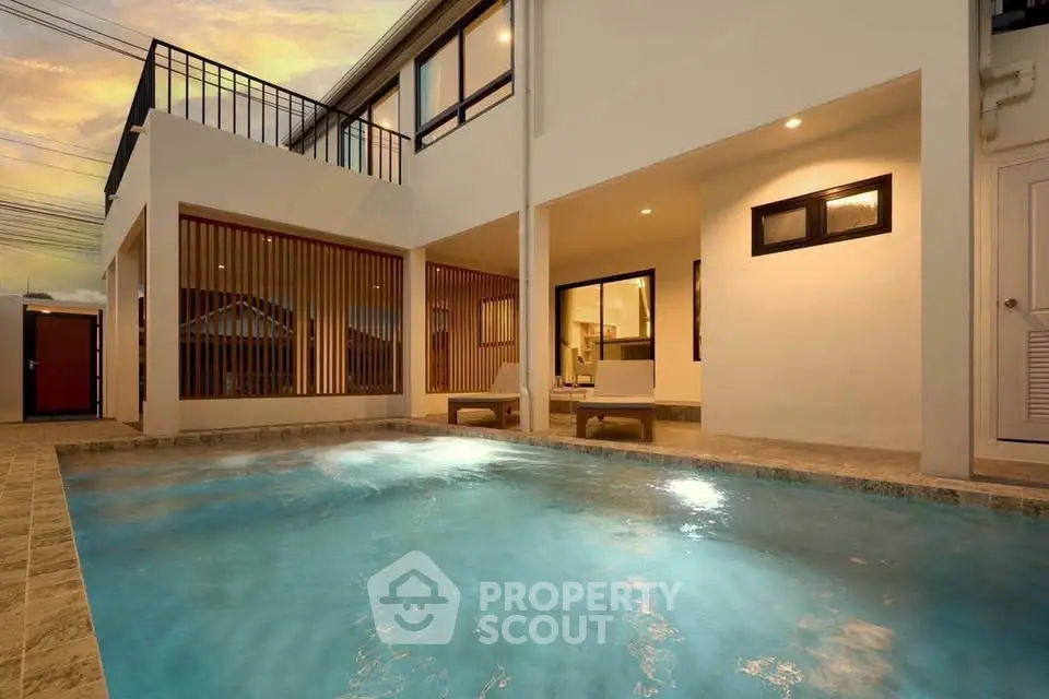 Luxurious modern home with stunning pool and elegant architecture at sunset.