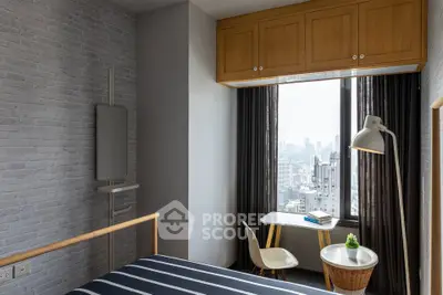 Modern bedroom with city view, featuring stylish decor and natural light.