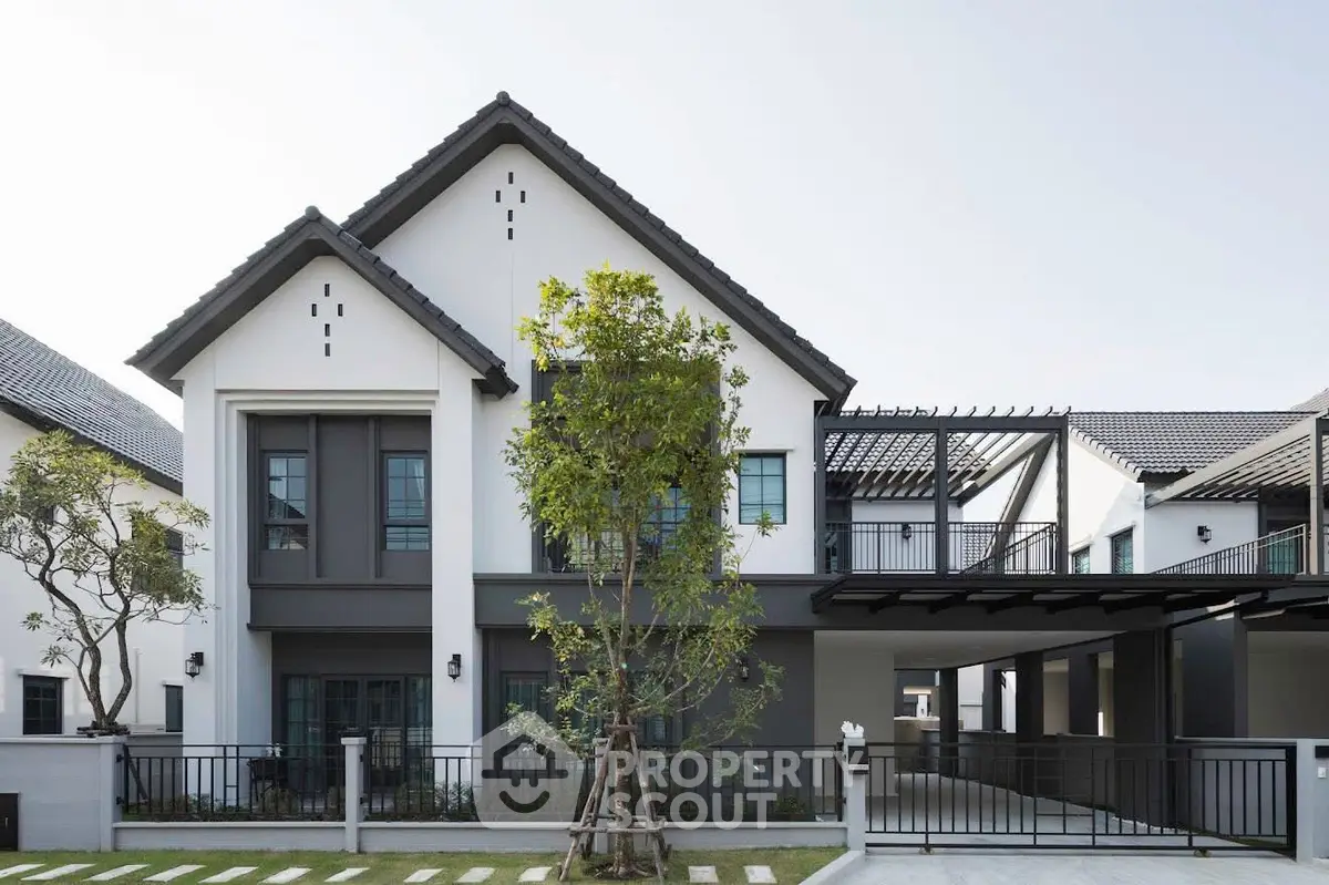 Modern two-story house with sleek design and spacious driveway in a serene neighborhood.