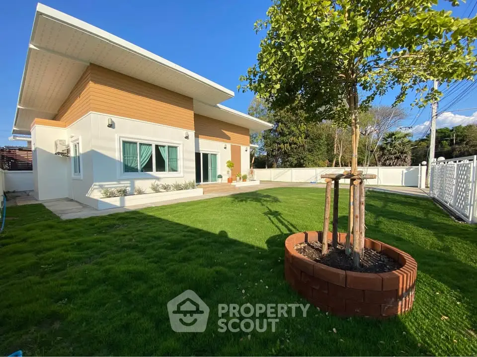 Modern single-story house with spacious green lawn and unique roof design.