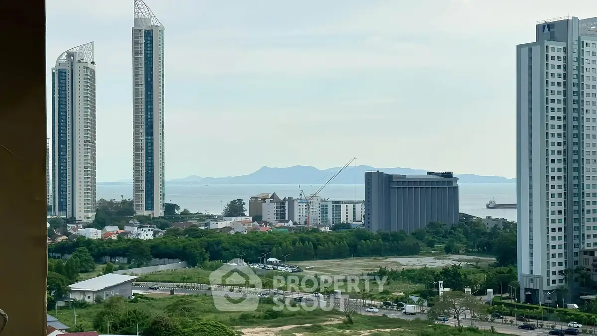 Stunning coastal cityscape view with modern high-rise buildings and lush greenery, perfect for urban living.