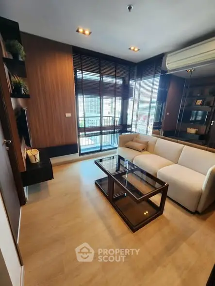 Modern living room with large windows and stylish furniture in a cozy apartment.