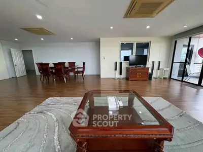 Spacious living room with elegant wooden furniture and modern decor in a luxurious apartment.