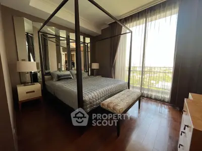 Luxurious bedroom with elegant four-poster bed and floor-to-ceiling windows offering stunning views.