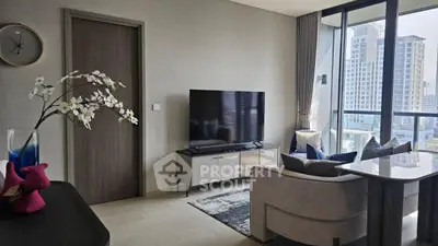 Modern living room with large TV and city view from window