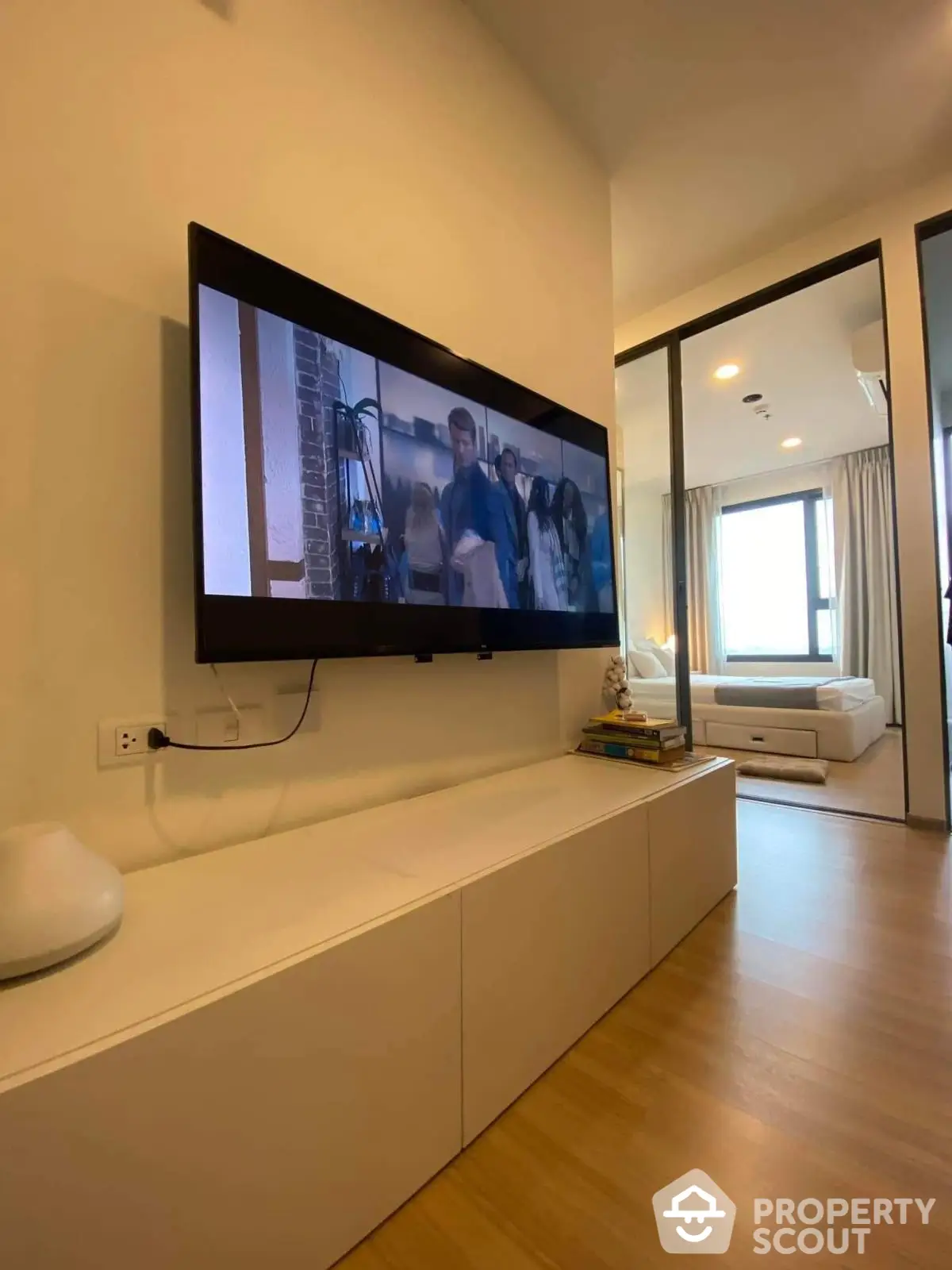 Modern living room with wall-mounted TV and sleek furniture