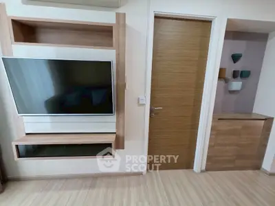 Modern living room with sleek TV setup and wooden accents