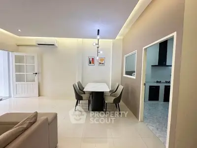 Modern dining area with elegant lighting and open kitchen view
