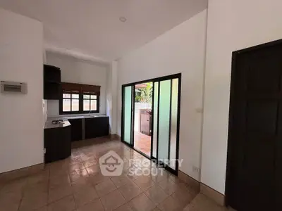 Spacious open-plan kitchen with sliding glass doors and natural light