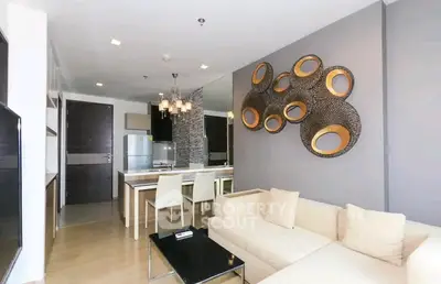 Modern living room with stylish decor and open kitchen layout in a contemporary apartment.