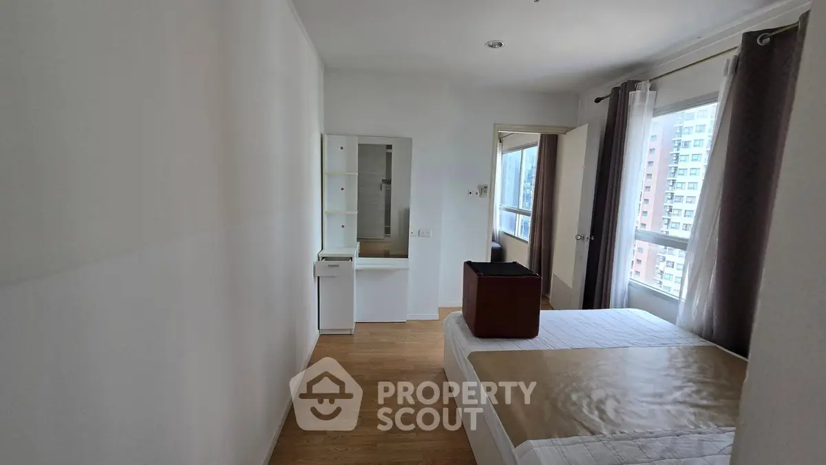 Bright bedroom with modern furniture and large window view