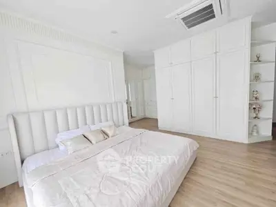 Luxurious white bedroom with elegant built-in wardrobes and plush bedding, perfect for serene relaxation.