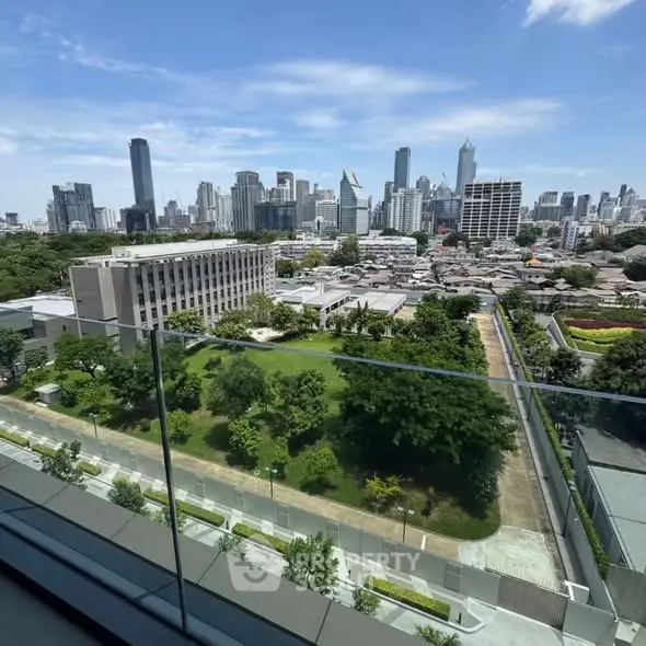 Stunning cityscape view from a modern balcony overlooking lush greenery and skyscrapers.