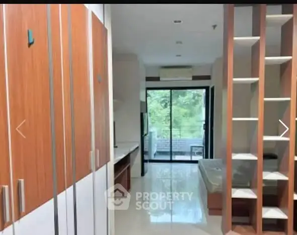Modern studio apartment with open layout and balcony view