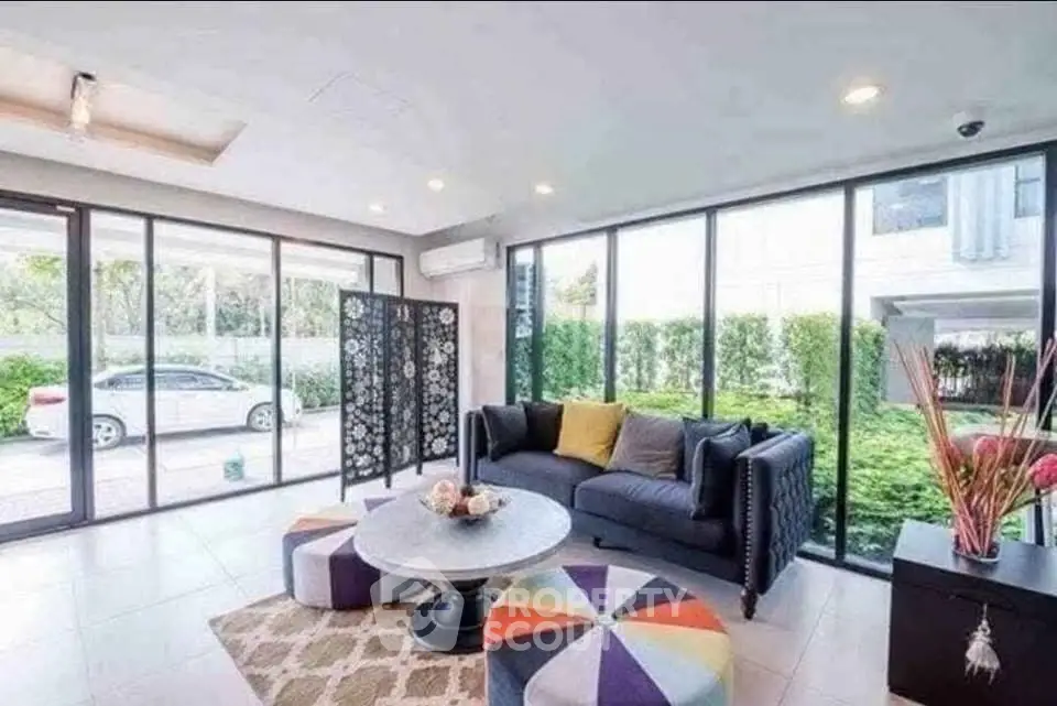 Modern living room with large windows and stylish decor