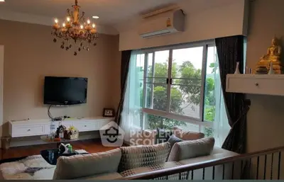 Elegant living room with chandelier and large window view