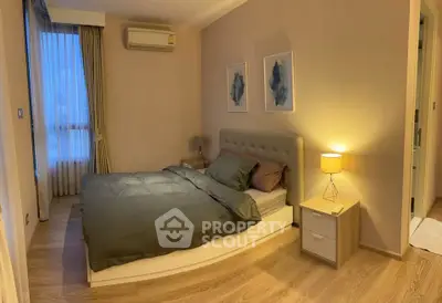 Cozy bedroom with modern decor and soft lighting, featuring a comfortable bed and stylish artwork.