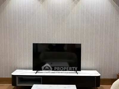 Modern living room with stylish TV stand and elegant wallpaper design.
