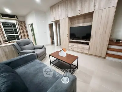 Modern living room with stylish furniture and built-in storage, perfect for cozy family gatherings.