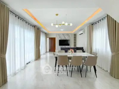 Spacious modern dining room with elegant lighting and large windows