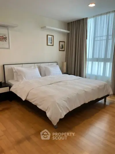 Spacious bedroom with elegant decor and natural light