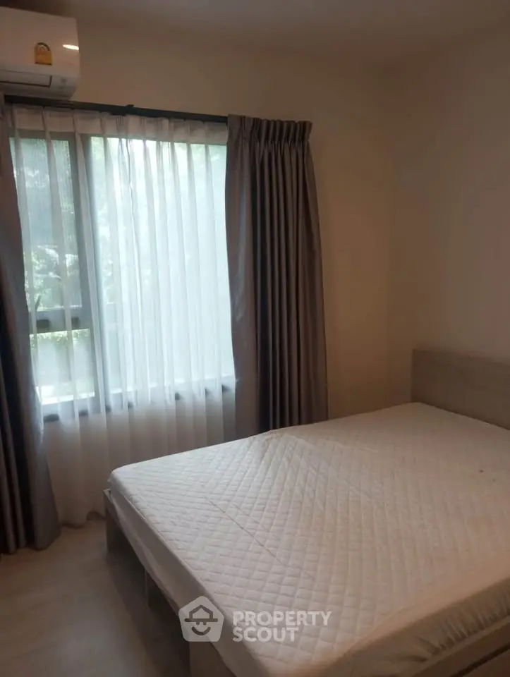 Cozy bedroom with natural light and modern furnishings, perfect for relaxation and comfort.
