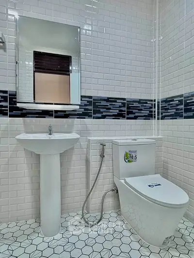 Modern bathroom with sleek white fixtures and stylish tile design