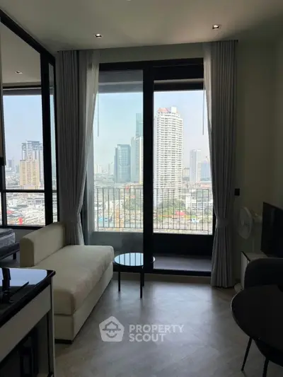 Modern living room with city view and large windows in a high-rise apartment.