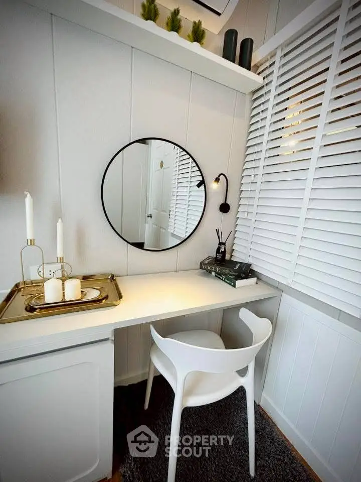 Chic study nook with modern white desk, stylish chair, and decorative accents in a cozy corner.