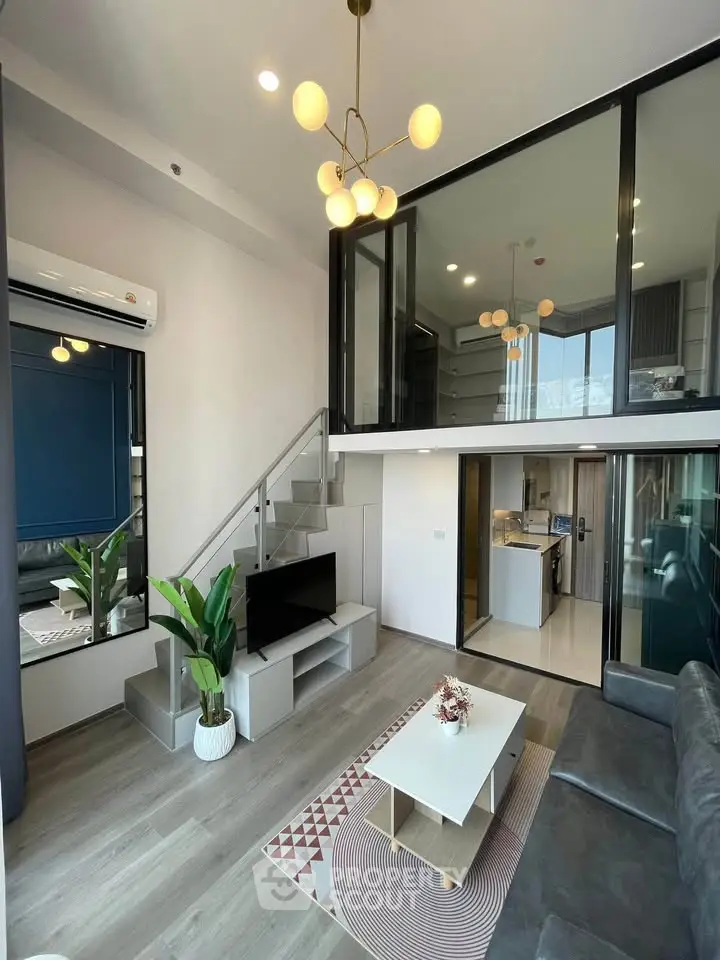 Modern duplex living room with stylish decor and open kitchen layout