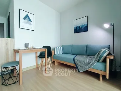 Modern living room with stylish furniture and decor, featuring a cozy sofa and dining area.
