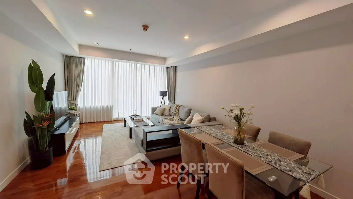 Spacious modern living room with elegant dining area and natural light.