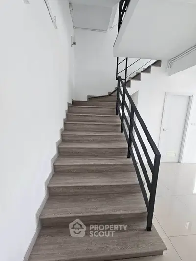 Modern staircase with sleek metal railing in a minimalist interior design