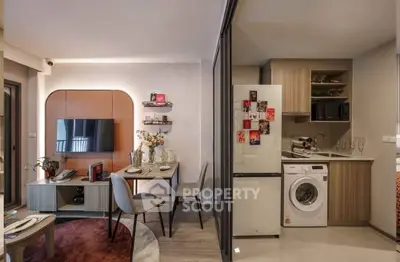 Modern open-plan living room and kitchen with stylish decor and appliances