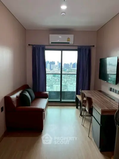 Modern living room with city view, featuring a cozy sofa and sleek wooden desk.
