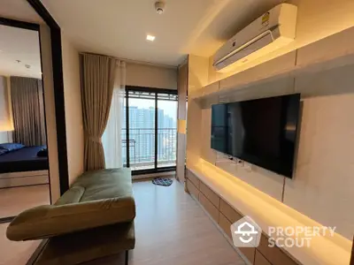 Modern living room with city view, stylish furniture, and wall-mounted TV in a high-rise apartment.